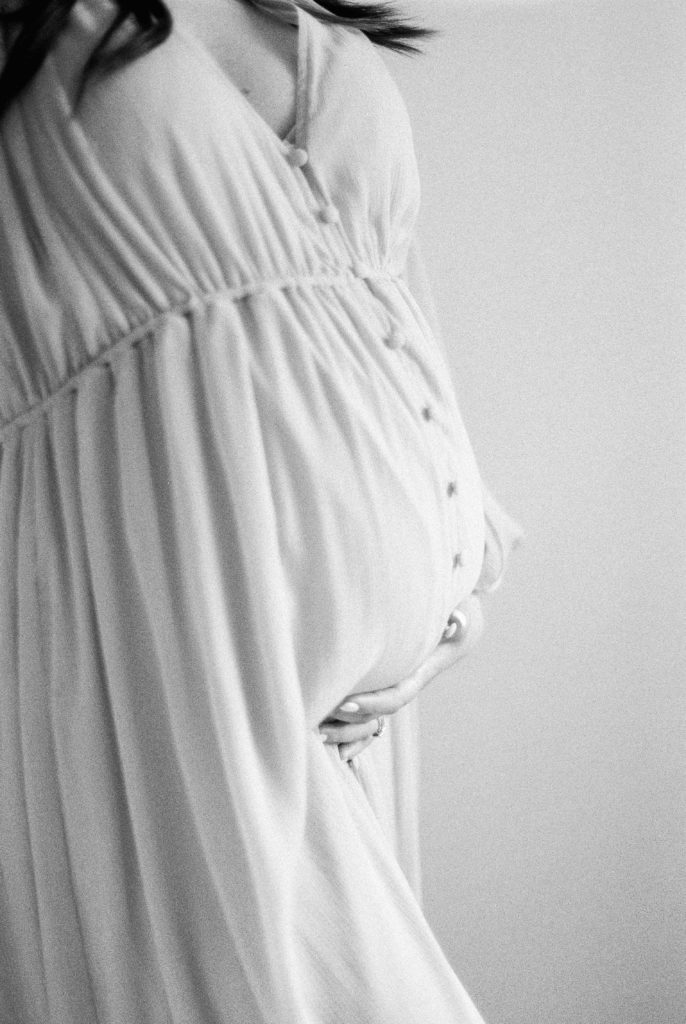 black and white film image of growing bump captured by Edmonton maternity photographer, Kahla Kristen Photography