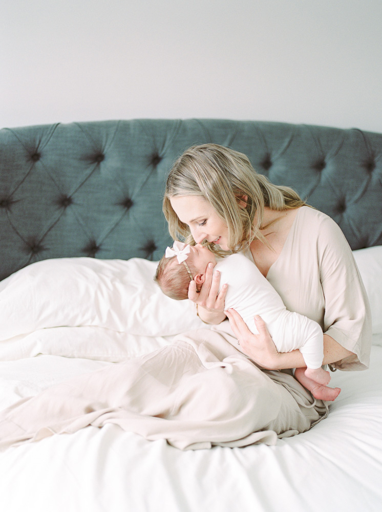 New mom holding baby in beautiful, light filled home, taken by Kahla Kristen Photography