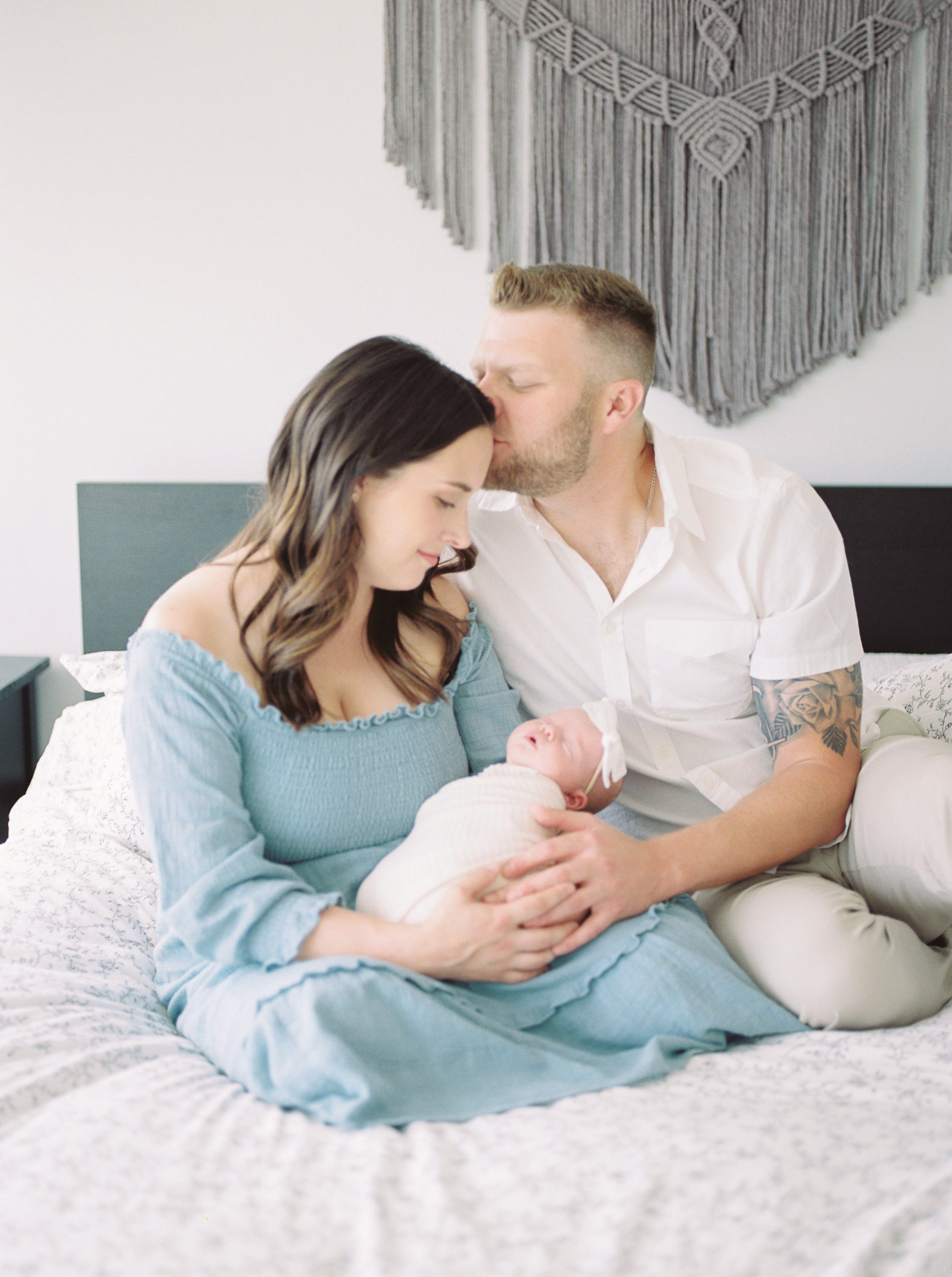 Natural light image of parents and newborn baby captured on film by Kahla Kristen Photography