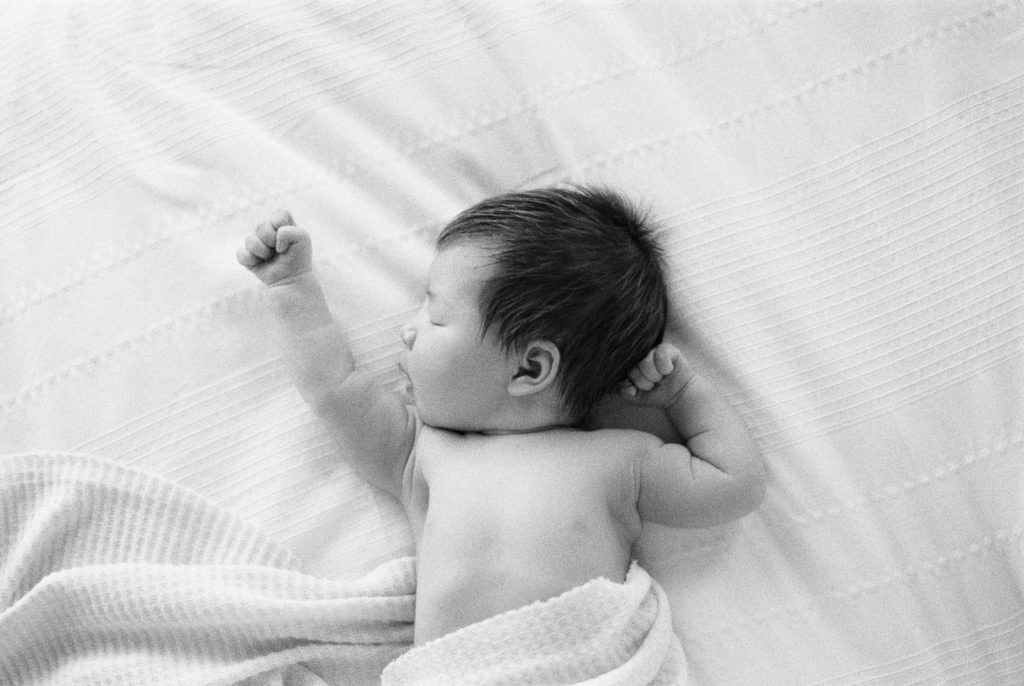 Newborn baby on black and white film