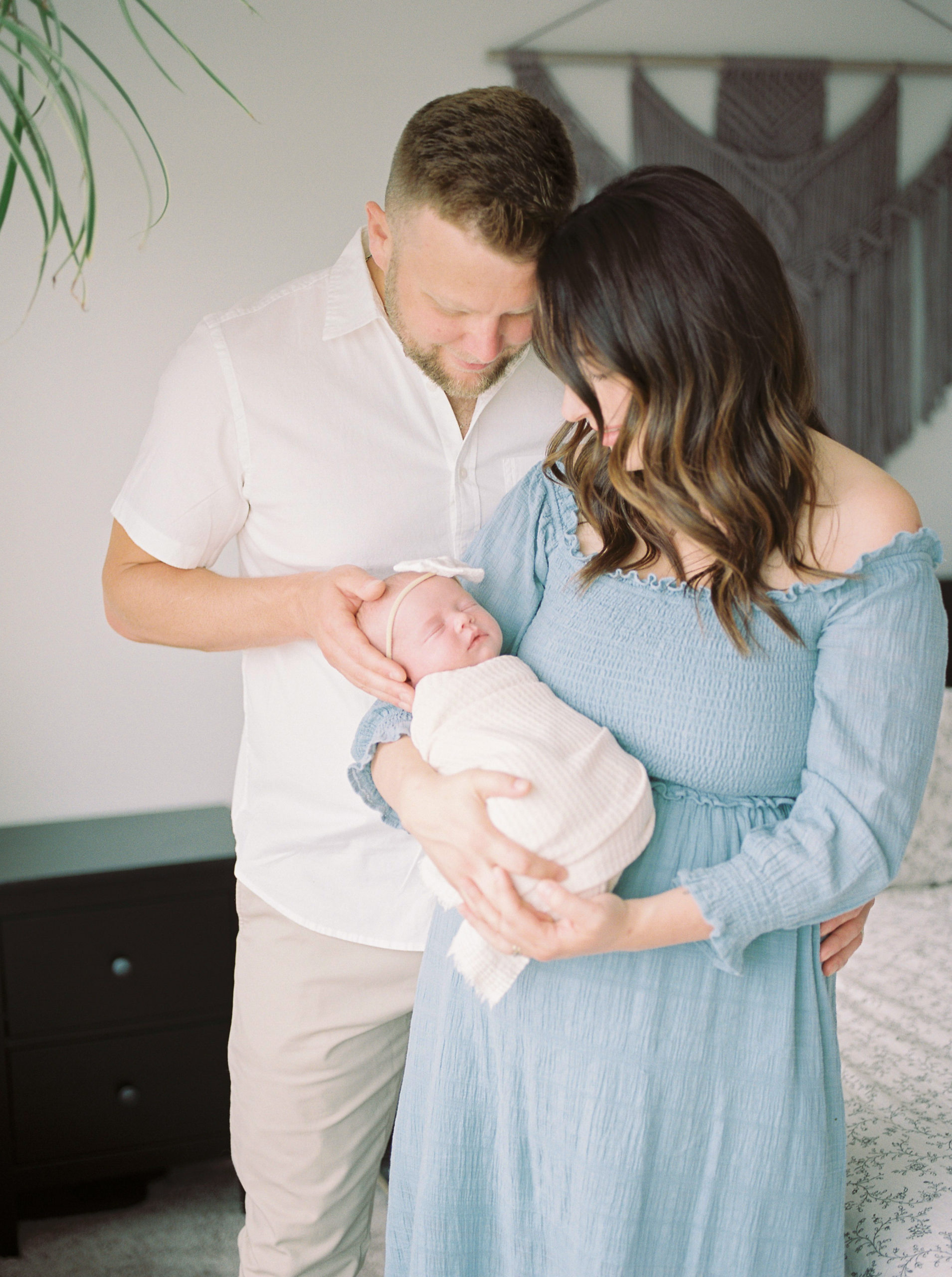 Natural light image of parents and newborn baby captured on film by Kahla Kristen Photography