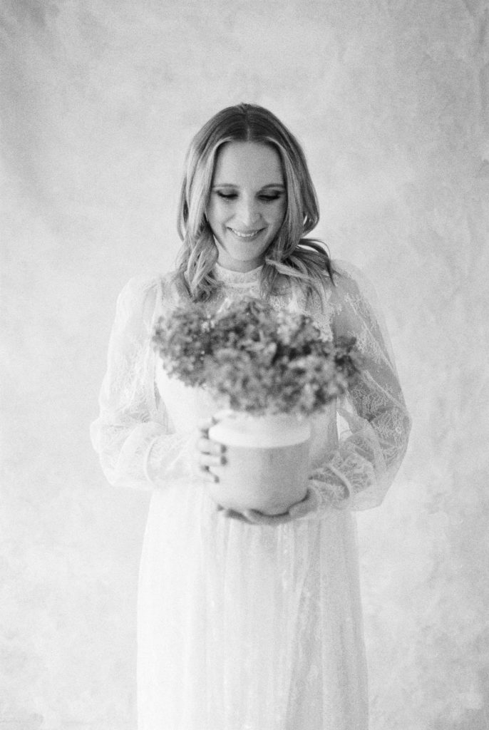 Black and white film image of expectant mother smiling