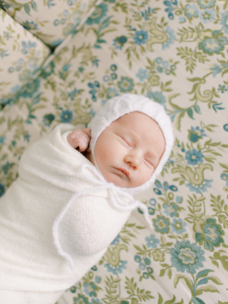newborn baby swaddled and sleeping calmly by edmonton newborn photographer Kahla Kristen Photography