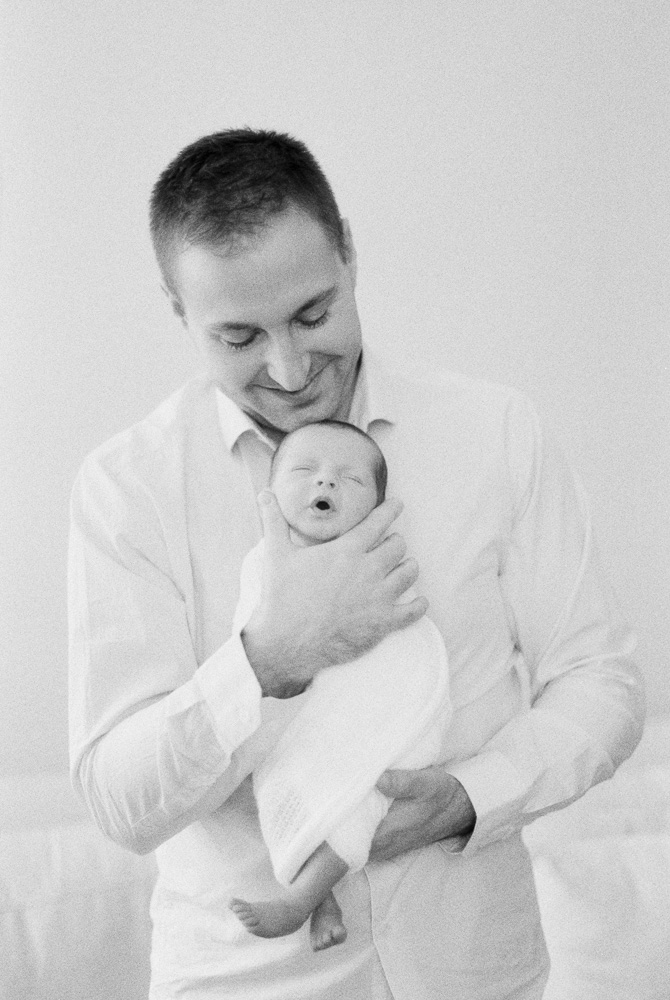 Edmonton Newborn Photography black and white image of dad holding baby