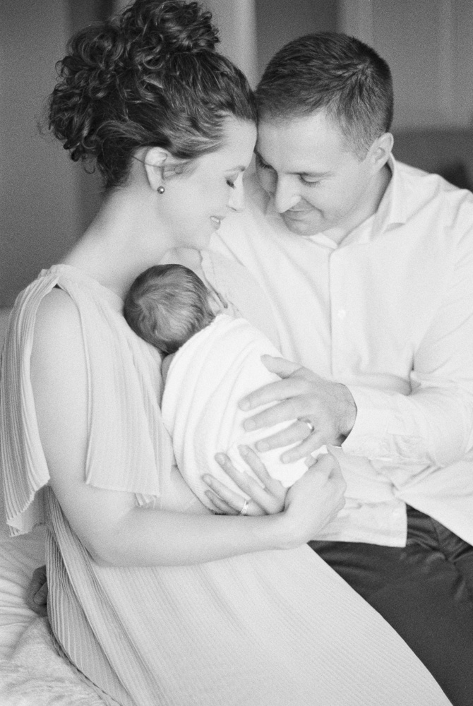 Newborn Photography Near Me, image of mom and dad and baby on black and white film