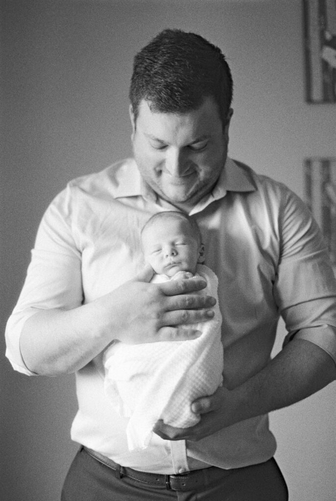 Edmonton newborn photography black and white image of dad and baby boy