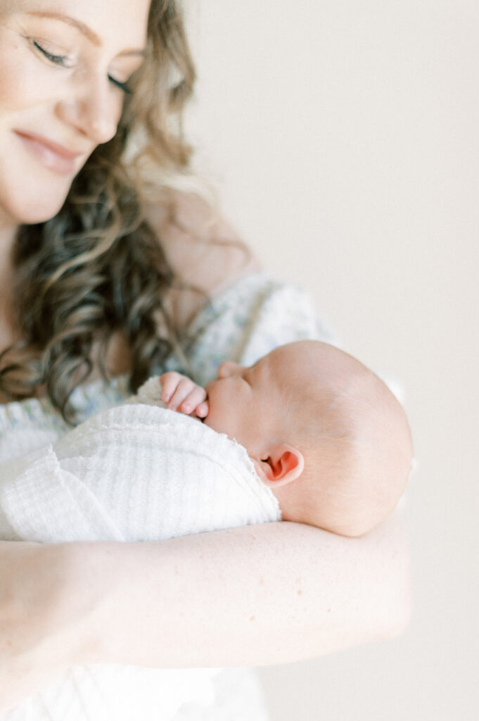 newborn baby in moms arms