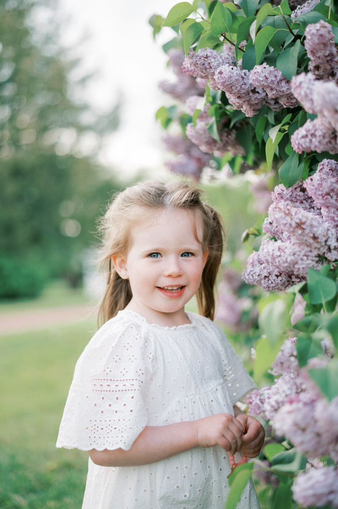 Little girl smiling in nature at best ice cream shop in Edmonton