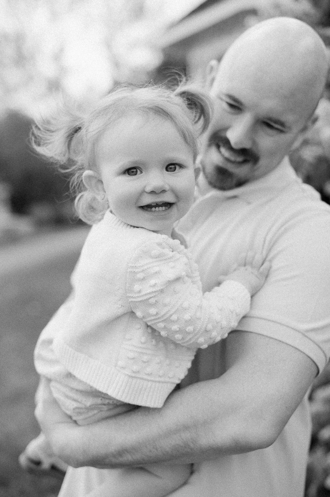 Dad holding daughter on beautiful summer evening at ice cream shop in Edmonton