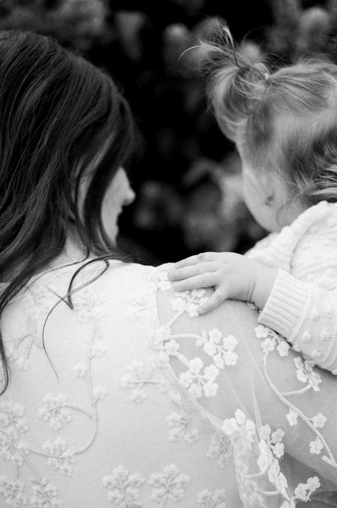 Mom holding daughter on beautiful summer evening at ice cream shop in Edmonton