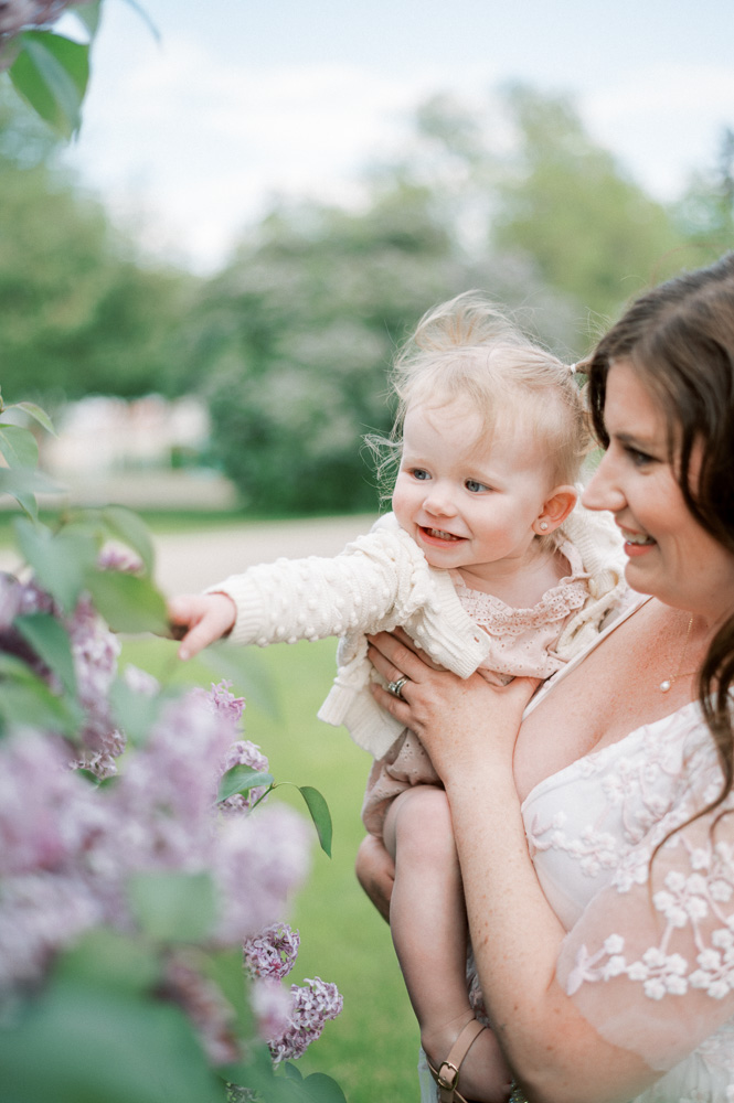 Mom holding daughter on beautiful summer evening at ice cream shop in Edmonton