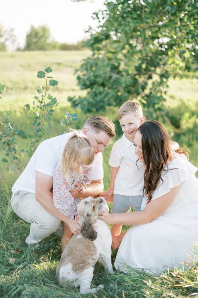 Beautiful family with dog outside in summer