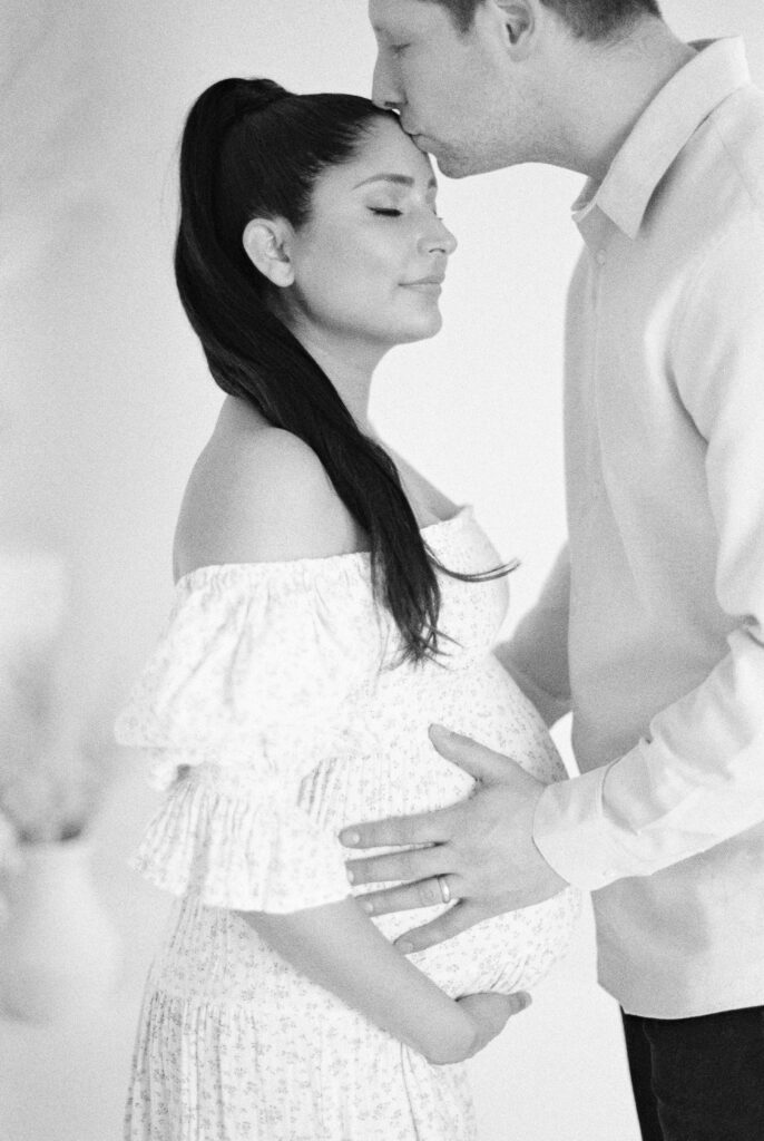 Edmonton photographer for beautiful maternity photos captures expectant mom and dad in black and white in studio