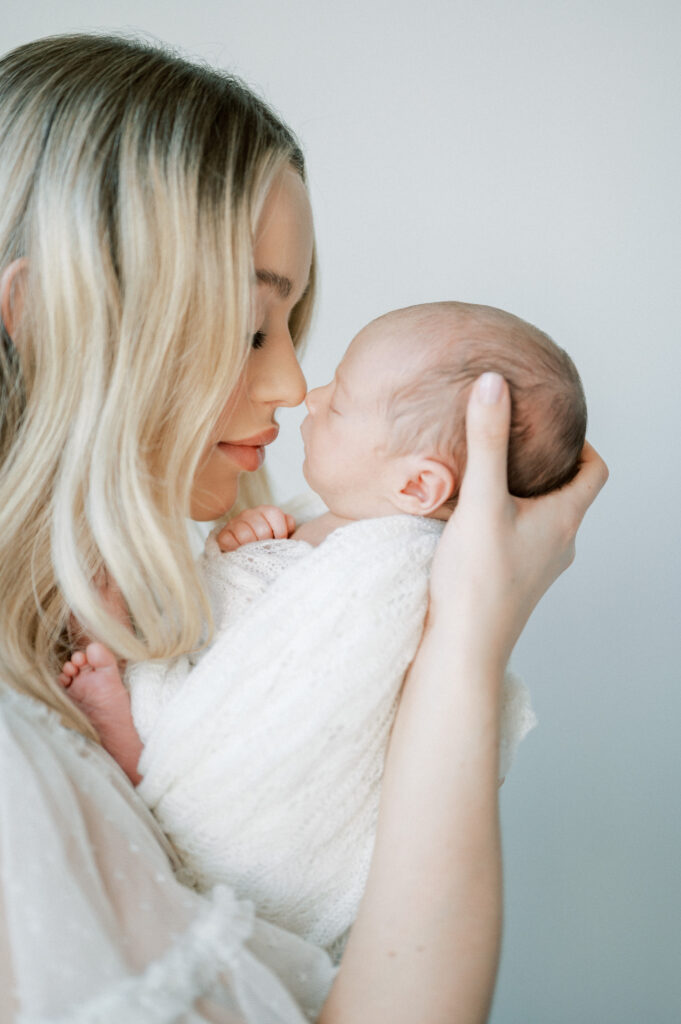 Mother holding newborn baby tenderly.